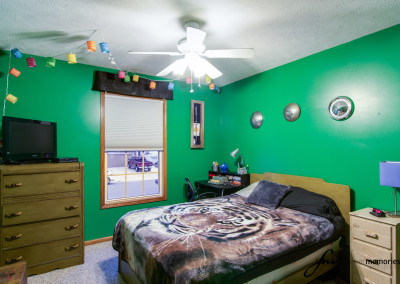 Bedroom with green walls and bed