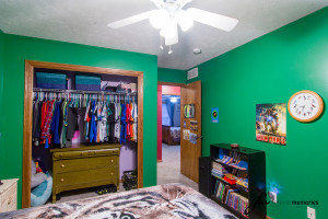 Bedroom with green walls and closet